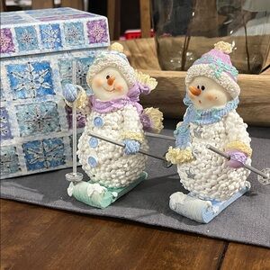 Charming Snowman Skiing Figurines - White and Pastel Accents